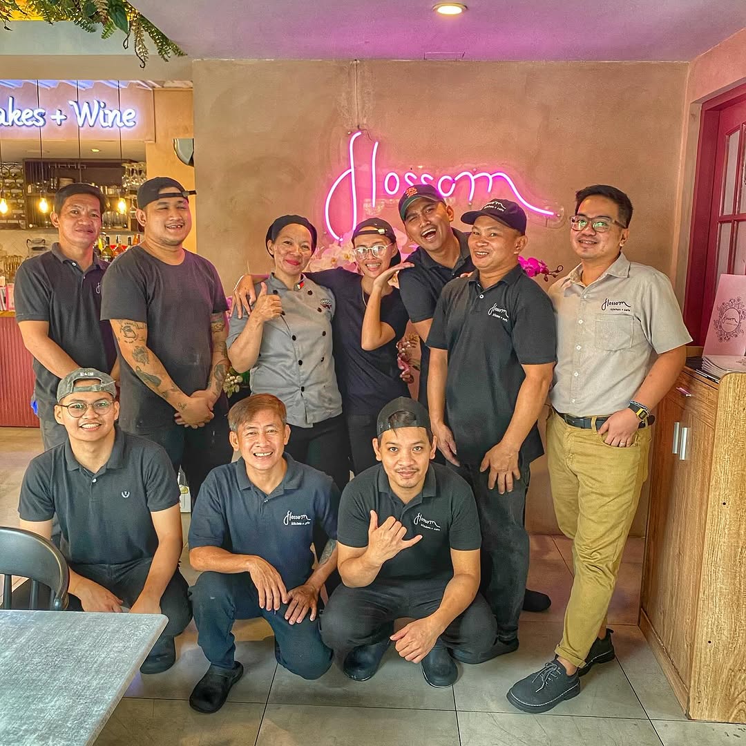 Flossom staff team photo in uniform with neon branding