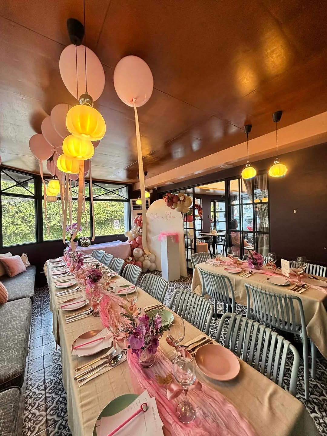 Flossom Glass House birthday setup with pink balloons and floral arrangements